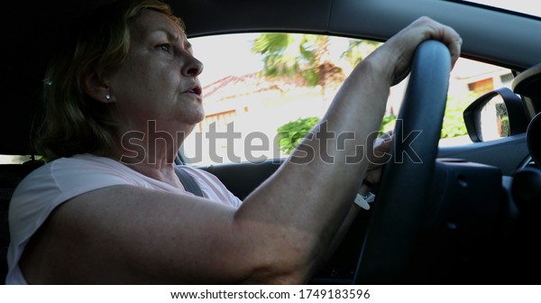
Upset older woman driving. Angry senior lady
driver holding steering
wheel