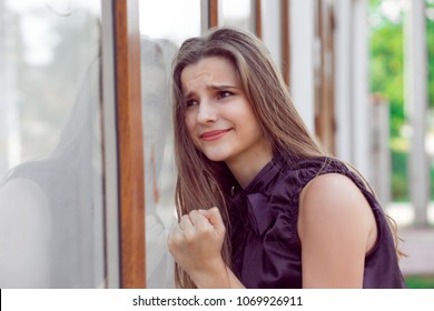 Upset Outside In The City. Beautiful Young Woman With Stressed About To Cry Near Her Office Store Window Fist On Glass Crying. Negative Human Emotions, Face Expression, Body Language Feelings Attitude