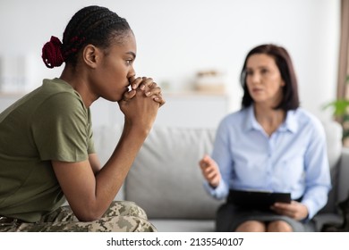 Upset Pensive Black Military Lady Having Therapy Session With Psychologist In Office, African American Soldier Woman Suffering Mental Illness Or Posttraumatic Stress Disorder, Selective Focus