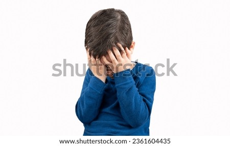 Upset problem child with head in hands concept for childhood bullying, depression stress or frustration with white background.