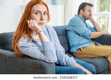 Upset and sad couple arguing with each other on sofa - Shutterstock ID 2182268317