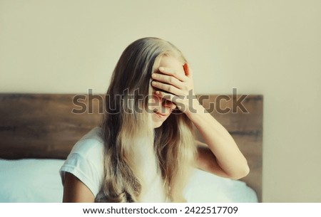 Similar – Young blonde woman with a headache