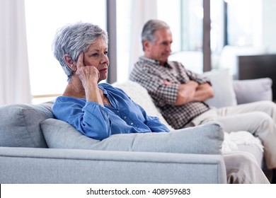 Upset senior couple ignoring each other at home - Powered by Shutterstock