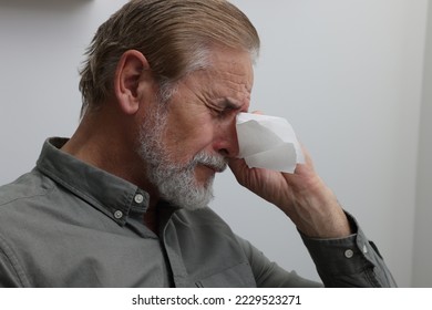 Upset senior man wiping tears with napkin at home, closeup. Loneliness concept - Powered by Shutterstock