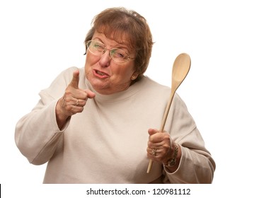 Upset Senior Woman with The Wooden Spoon Isolated on a White Background.