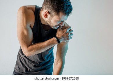 Upset Sportsman Feeling Pain In Shoulder. Young Bearded European Man Wear Sports Uniform. Concept Of Sports Injury. Isolated On Turquoise Background. Studio Shoot. Copy Space