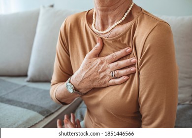 Upset Stressed Mature Middle Aged Woman Feeling Pain Ache Touching Chest Having Heart Attack, Sad Worried Senior Older Lady Suffers From Heartache At Home, Infarction Or Female Heart Disease Concept