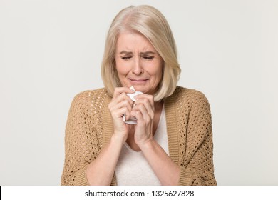 Upset Stressed Old Mature Woman Crying Feeling Loneliness, Sad Depressed Aged Senior Lady Grandma Holding Handkerchief Weeping Isolated On Grey White Studio Background, Sorrow Grief Poverty Concept