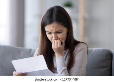 Upset Stressed Teen Girl Feeling Worried Reading Bad News In Paper Mail Letter Concerned About Financial Problem, Bank Debt, Millennial Woman Student Anxious About Expulsion Failed Exam Test Results