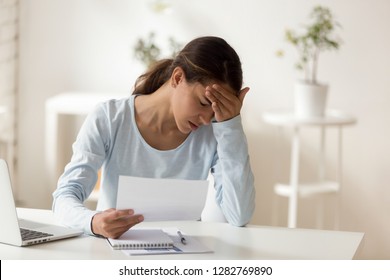 Upset stressed woman reading dismiss or debt notification, sitting at home or in office, bad news receiving concept, frustrated female student holding paper document, failed exam, rejection