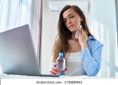 Upset Sweating Working Woman Suffering From Heat And Thirst Wipes His Neck With A Napkin During Online Remote Work At Computer At Home At Hot Summer Day