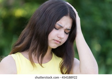 Upset Teen Girl Holding A Hand Behind His Head