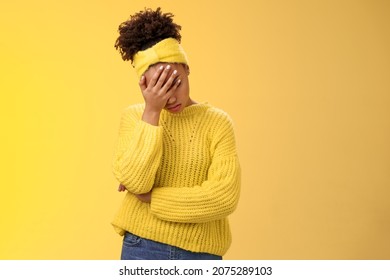 Upset tired african-american female entrepreneur facepalm bow head close eyes palm pressed face embarrassed stupid inappropriate behaviour drunk coworker standing annoyed irritated yellow background