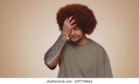 Upset Tired, Bored Man In T-shirt Making Face Palm Gesture, Feeling Bored, Disappointed In Result Of Work, Bad News. Young Guy Disappointed, Helpless Isolated Alone On Beige Studio Wall Background