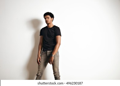 Upset Tired Muscular Black Young Man In An Unlabeled Cotton T-shirt And Skinny Jeans Isolated On White