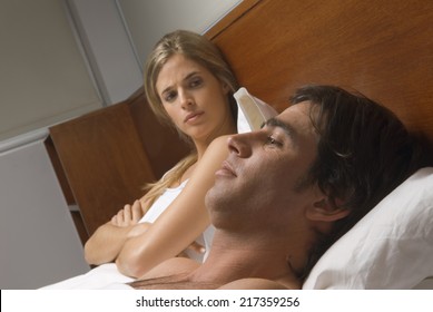 Upset Woman In Bed With Man