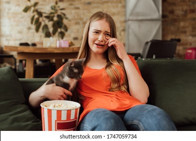 Upset Woman Crying Near Cat And Popcorn Bucket While Watching Movie