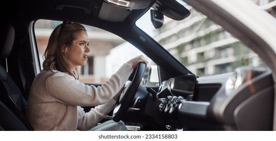 Upset woman driving her car in a city.