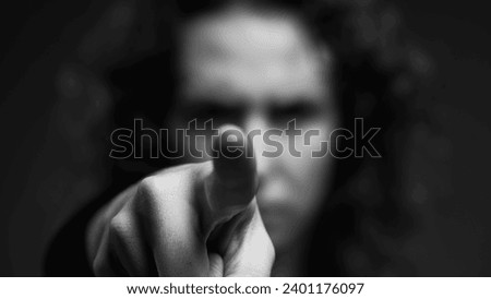 Upset Woman Making 'X' with Hands and Pointing Finger at Camera, Waving 'NO' in Rejection in intense monochromatic, black and white
