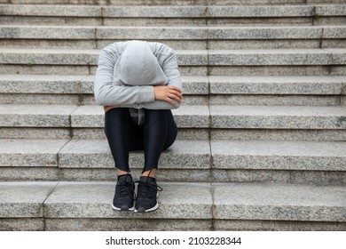 Upset woman sitting alone in city stairs - Powered by Shutterstock