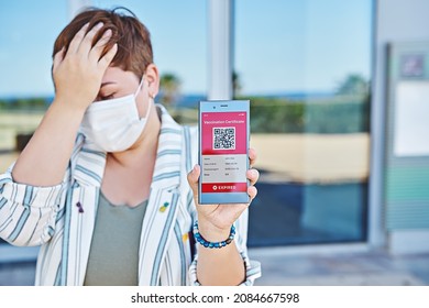 Upset woman tourist with smartphone displaying on app mobile expired digital vaccination certificate for Covid-19 QR Code. Immunity vaccine passport, green vaccination certificate, health e-passport
