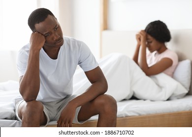 Upset Young African American Couple After Fight In Bedroom, Sad Man And Woman Sitting In Bed Apart. Frustrated Black Man And Woman Having Fight, Thinking About Divorce Or Breaking Up, Home Interior