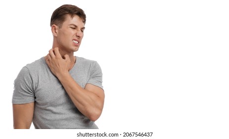 Upset Young Caucasian Male Suffering From Irritation And Scratching Skin On Neck, With Painful Facial Expression, Isolated On White Background. Eczema, Atopic Dermatitis, Allergy, Psoriasis And Itchy