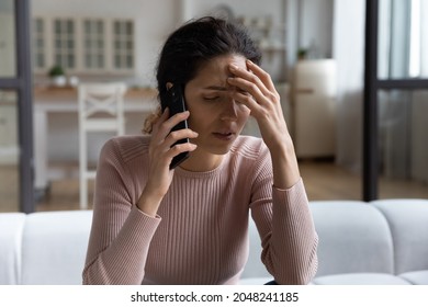 Upset young Caucasian woman have cellphone call hear bad unpleasant news on gadget. Unhappy millennial female talk speak on smartphone distressed frustrated with negative message. Failure concept. - Shutterstock ID 2048241185