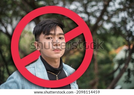 An upset young man after being called out or ostracized in social media or in person. Cancel culture concept. With stop sign graphic. Stock photo © 