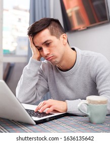 Upset Young Man Counts Family Budget On Laptop