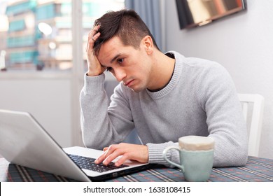 Upset Young Man Counts Family Budget On Laptop