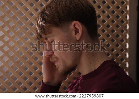 Upset young man during confession in church