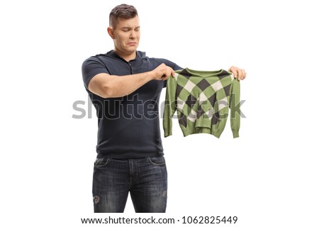Upset young man with a shrunken blouse isolated on white background