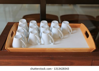 Upside down cup for coffee on wood tray.