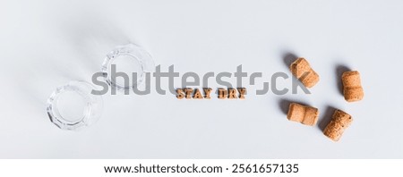 Upside down glasses, corks and text, sober january concept on grey background