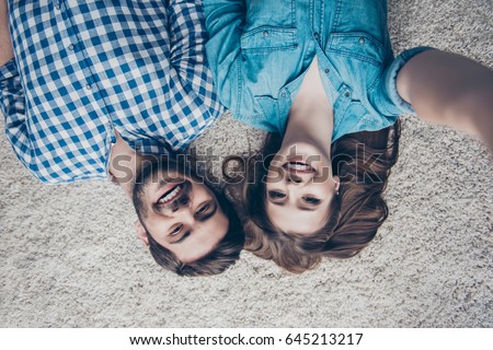 Similar – Women friends with sunglasses looking each other lying