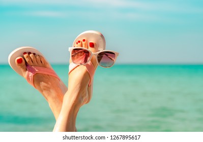 Upside Woman Feet And Red Pedicure Wear Pink Sandals, Sunglasses At Seaside. Funny And Happy Fashion Young Woman Relax On Vacation. Chill Out Girl At Beach. Creative For Tour Agent. Summer Vibes.