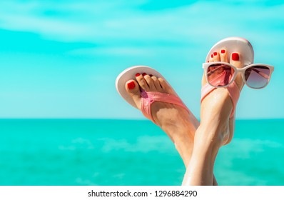 Upside Woman Feet And Red Pedicure Wear Pink Sandals, Sunglasses At Seaside. Funny And Happy Fashion Young Woman Relax On Vacation. Girl On Beach. Creative For Tour Agent. Weekend Travel. Summer Vibes