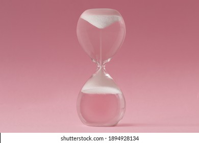 Upside-down Hourglass On Pink Background - Concept Of Reverse Time