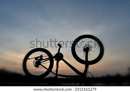 upsidedown mountain bicycle in sunrise sky view as artistic background 