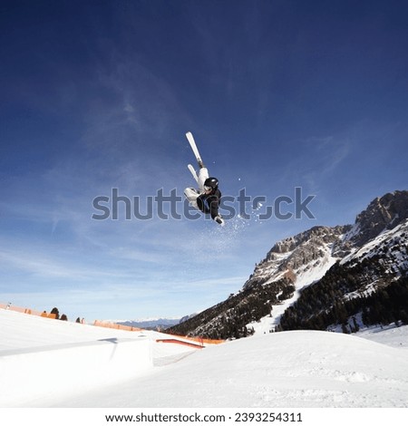 upsidedown skier snowpark jumping trick with style