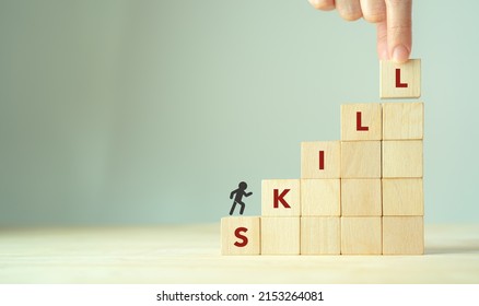 Upskilling and personal development concept. Skill training, education, learning, ability, knowledge and competency  for digital transformantion. Upskilling, reskilling, new skills icon on wooden cube - Shutterstock ID 2153264081