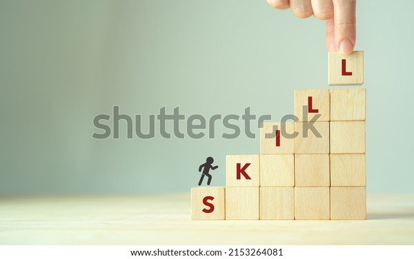 Upskilling and personal development concept. Skill\
training, education, learning, ability, knowledge and competency \
for digital transformantion. Upskilling, reskilling, new skills\
icon on wooden cube
