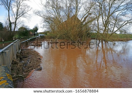 The upstream side ofthe flooded Forge Lane of the River leadon, Forge End, Highleadon, near Newent, Gloucestershire, UK