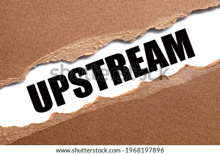 UPSTREAM. text inside torn paper. white sheet with black font.