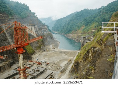 Upstream view of an ongoing construction work of a hydroelectric dam over a torrential hill stream in the Himalayas. 