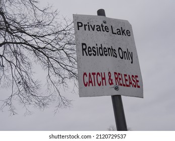 Upward Shot Of A Private Lakeside Sign For Catch And Release Fishing