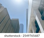 Upward view glass office building, skyscraper, high-rise condo towers under clear blue sky in downtown Dallas, Texas, urban architecture background, leasing space commercial and business center. USA