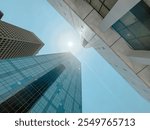 Upward view glass office building, skyscraper, high-rise condo towers under clear blue sky in downtown Dallas, Texas, urban architecture background, leasing space commercial and business center. USA