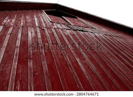 Upward view of rustic red barn siding with peeling paint, showcasing aged wood texture and vintage rural character, Driftless Barn Yard